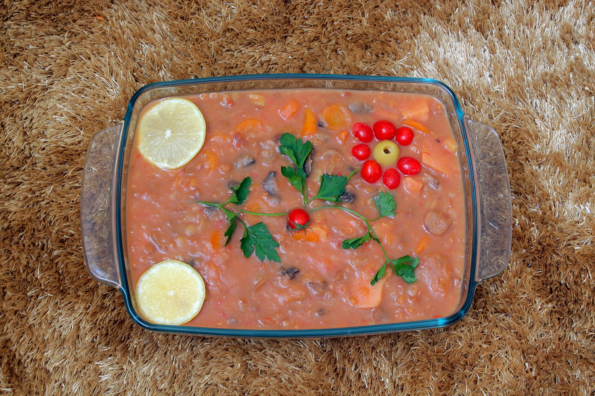 Bowl of Iranian lentil stew served with bread