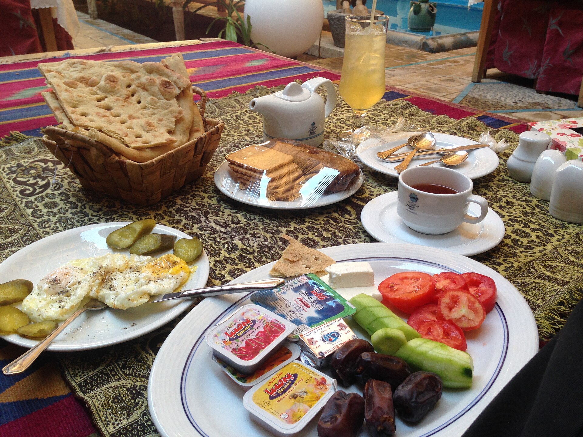 Persian breakfast spread with flatbread, cheese, tea, tomato and eggs