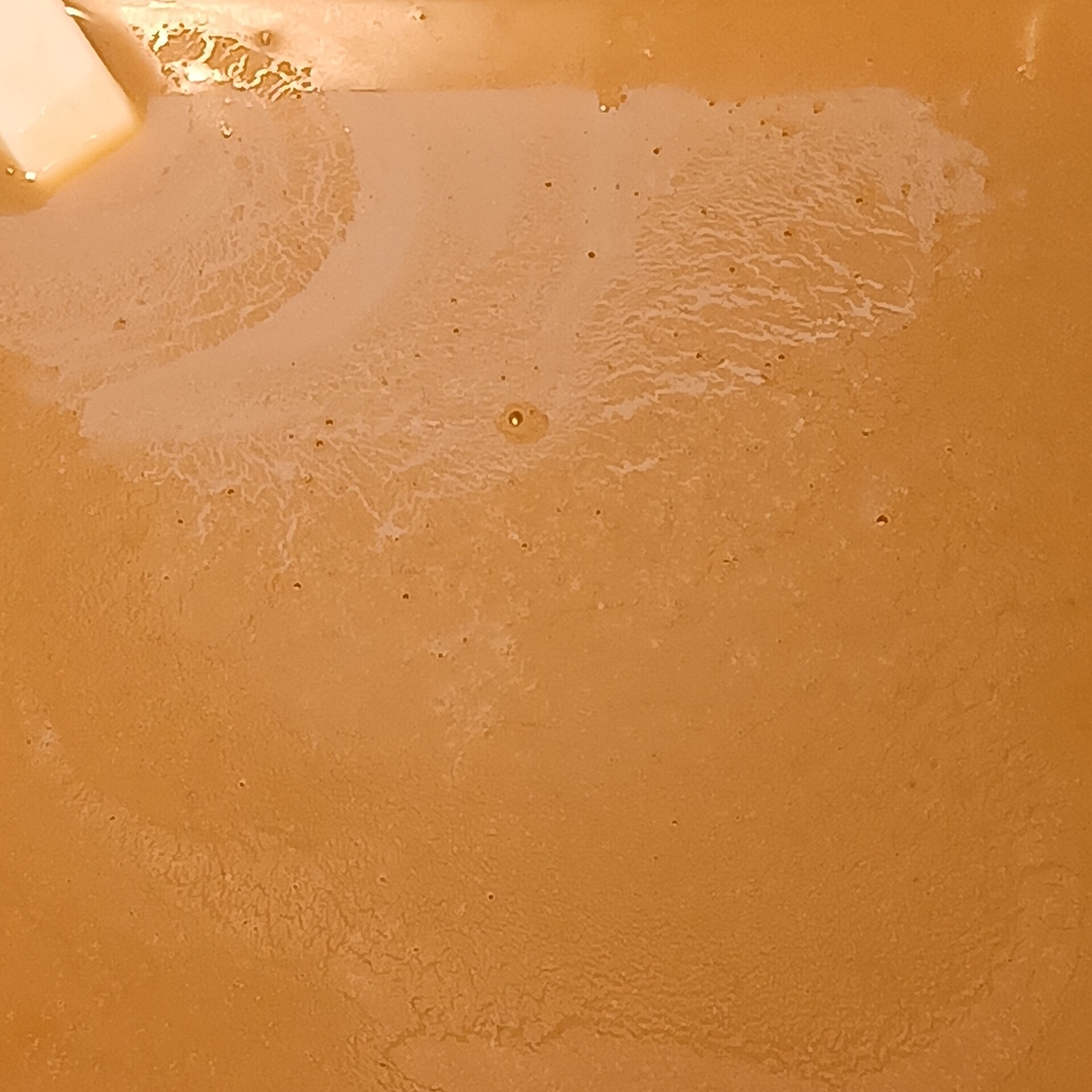 Bowl of smooth pale sesame paste with a spoon