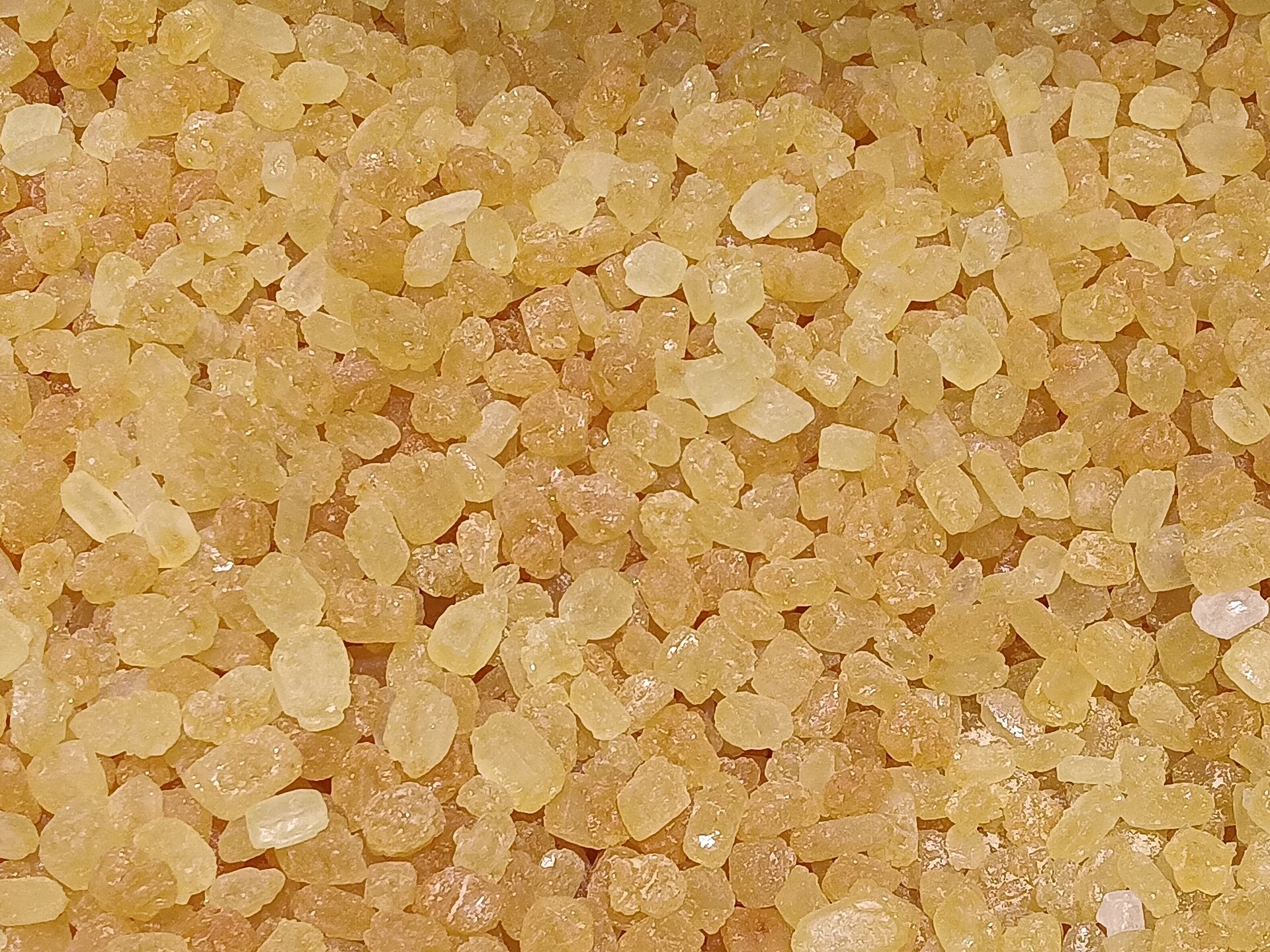 A single large yellow rock sugar crystal